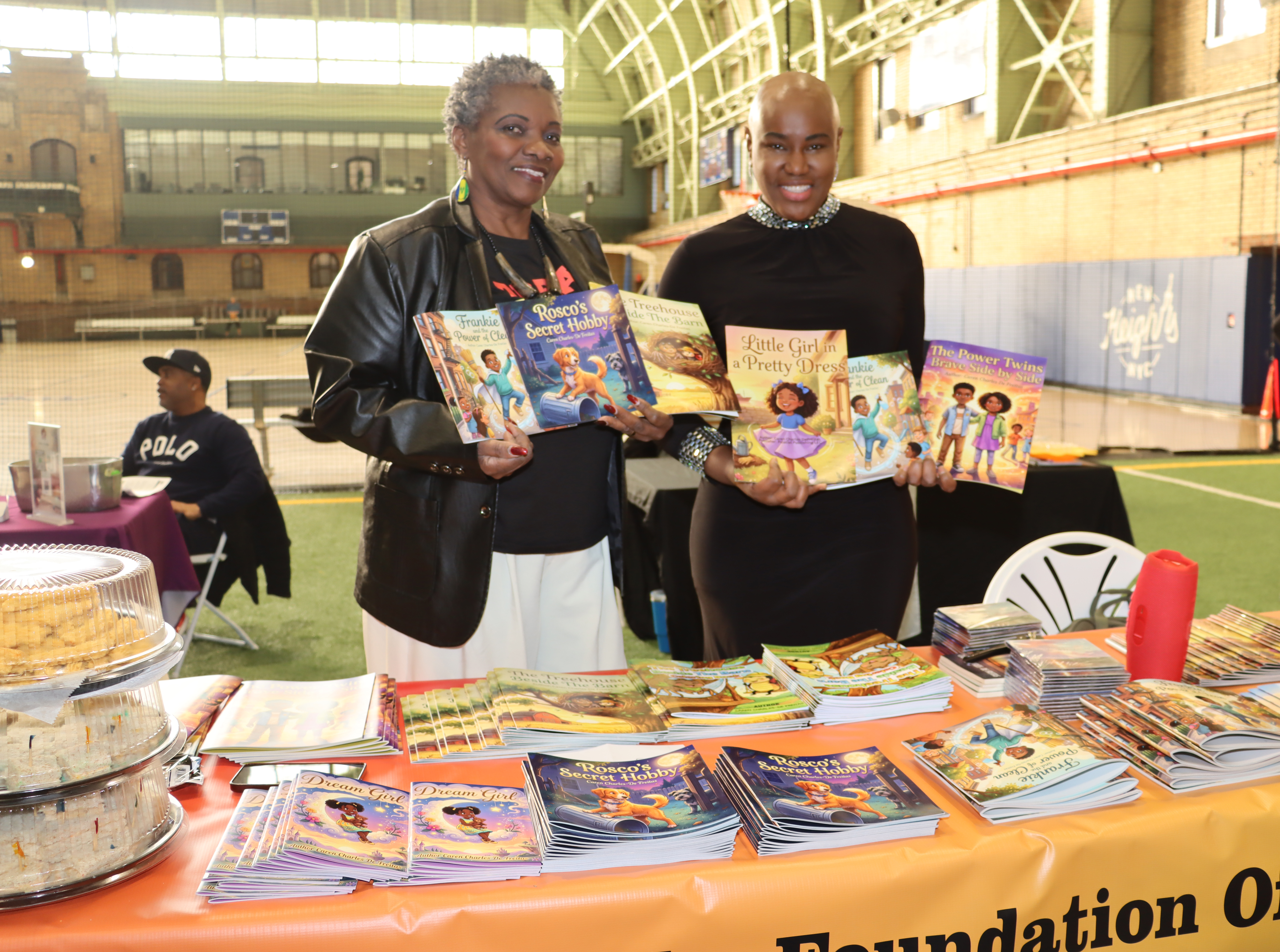 Kamla Millwood, right, with Vincentian author Caren Charles De Freitas, displaying books written by Charles De Freitas and published by Millwood's Palatial Publishing, LLC.