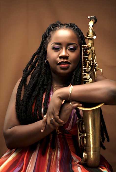 Michelle Henry poses with her saxophone.