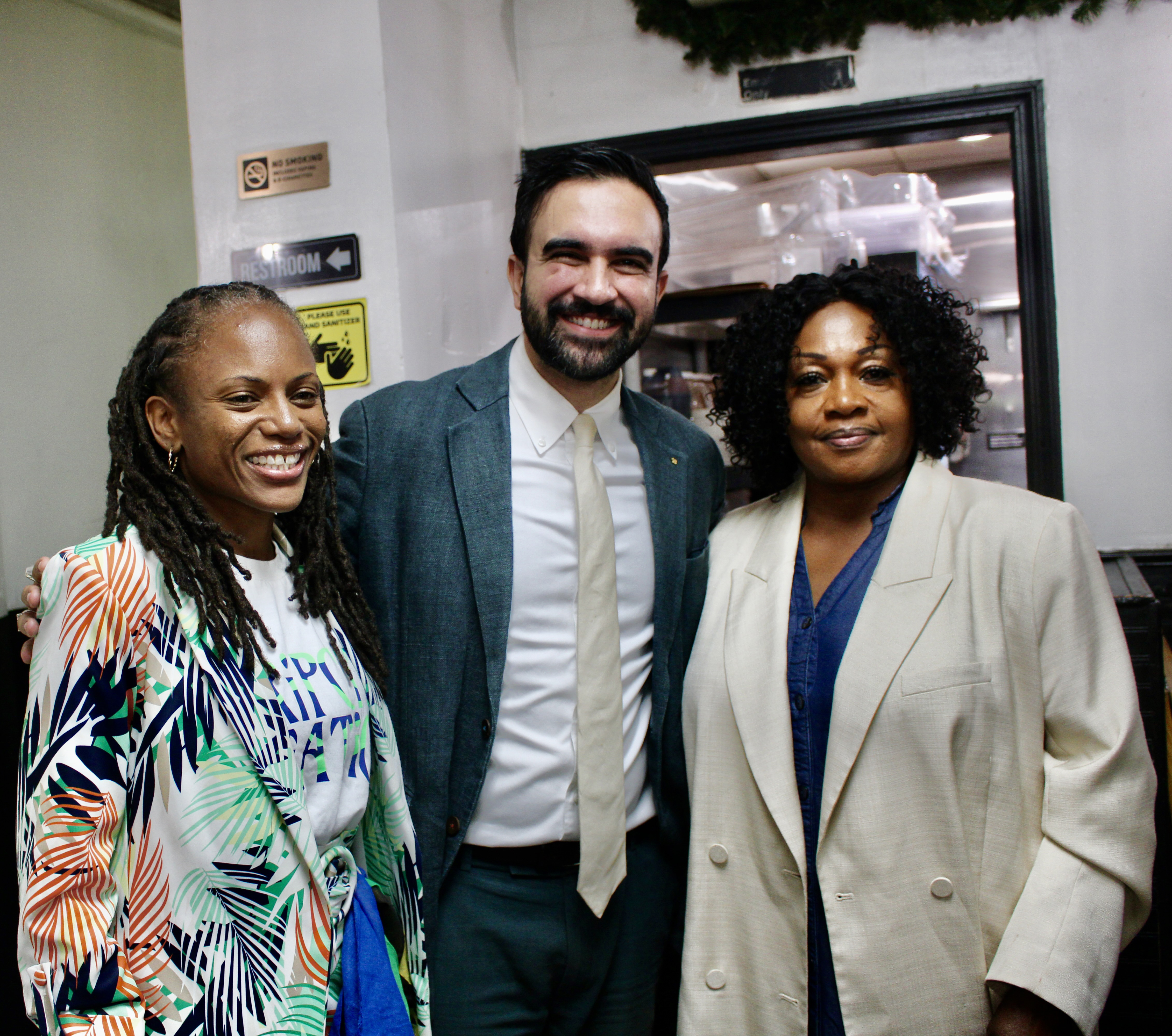 Mayor of the City of New York Zohran K. Mamdani, center, with Assembly Member Monique Chandler-Waterman, left, and owner of the Hills Restaurant Doris Rodney, after a 2025 walkabout in Little Caribbean in Brooklyn.