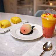 Fresh fruit desserts, including durian, mango pancakes and a mango strawberry smoothie, are displayed at the Mango Mango café in Astoria.