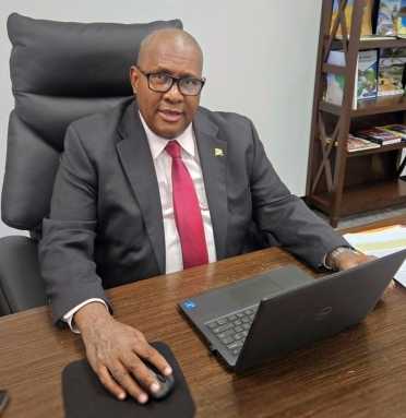 Consul General of Guyana to New York Ambassador Michael E. Brotherson at his desk after speaking with Caribbean Life at the diplomatic office, 228 E 45th St. in New York City.