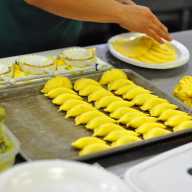 An employee makes Empanadas in the Bronx CookSpace kitchen.