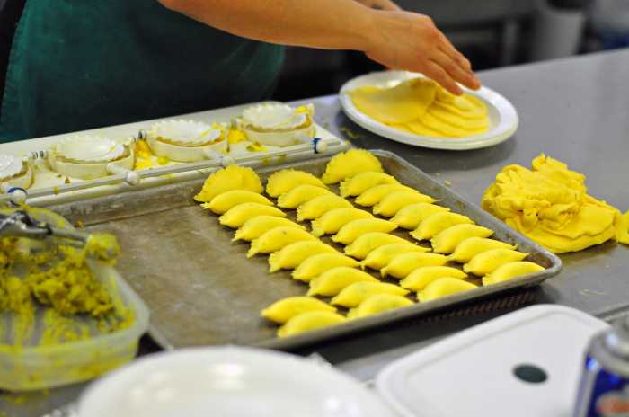 An employee makes Empanadas in the Bronx CookSpace kitchen.