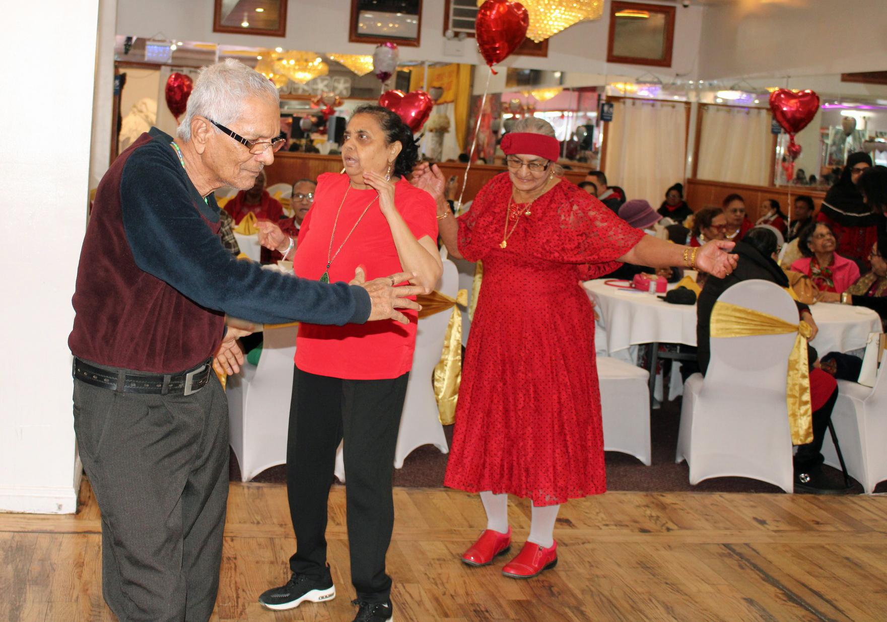 Seniors on the dance floor enjoying Bollywood songs performed by entertainers, during the 5th Annual V-Day hosted by ICF, in collaboration with United Adult Care, at Liberty Palace in Richmond, Queens.