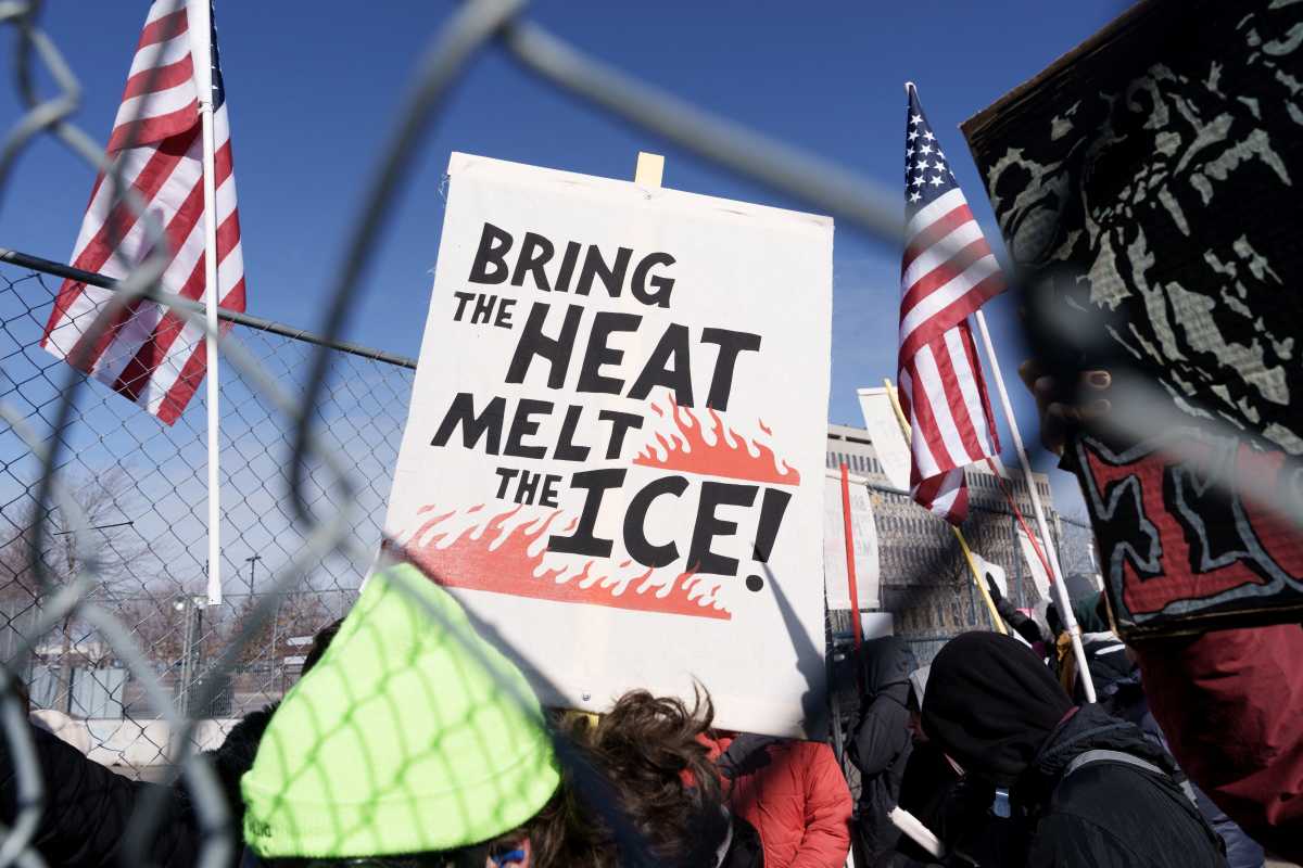 A protesters holds a sign outside the Whipple Federal Building during a demonstration against ongoing Immigration and Customs Enforcement (ICE) operations, in Fort Snelling, Minnesota, U.S., March 1, 2026.