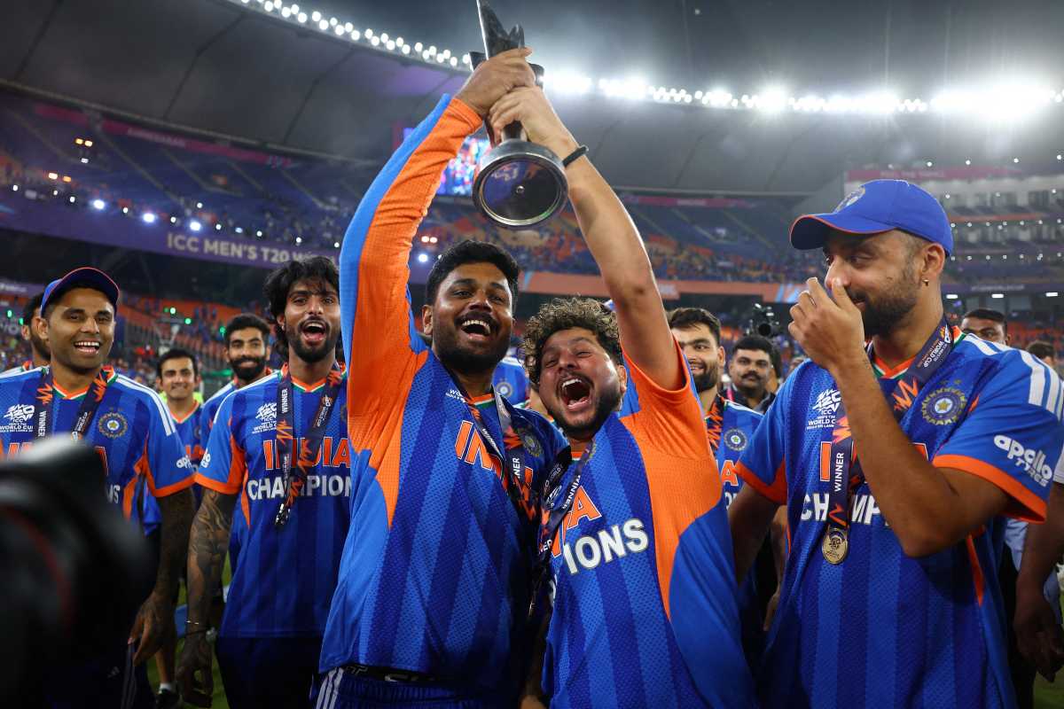 Narendra Modi Stadium, Ahmedabad, India - March 8, 2026: India's Kuldeep Yadav and Mohammed Siraj celebrates with the trophy after winning the ICC Men's T20 World Cup.
