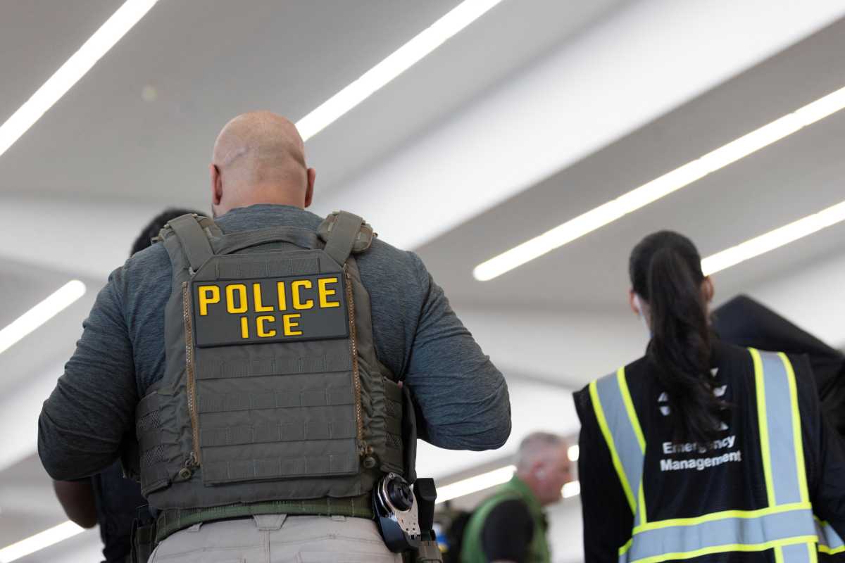 United States Immigration and Customs Enforcement (ICE) agents are present as passengers wait in line at a Transportation Security Administration (TSA) checkpoint after hundreds of Immigration and Customs Enforcement agents were ordered to deploy to airports to help fill TSA staffing gaps, at Hartsfield-Jackson Atlanta International Airport in Atlanta, Georgia, U.S. March 23, 2026.