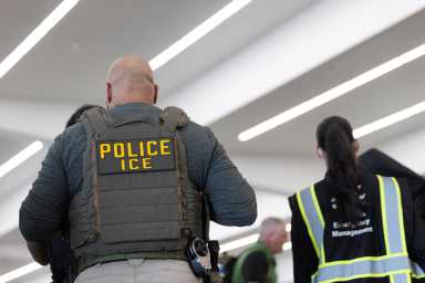United States Immigration and Customs Enforcement (ICE) agents are present as passengers wait in line at a Transportation Security Administration (TSA) checkpoint after hundreds of Immigration and Customs Enforcement agents were ordered to deploy to airports to help fill TSA staffing gaps, at Hartsfield-Jackson Atlanta International Airport in Atlanta, Georgia, U.S. March 23, 2026.