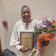 Trinidadian-born nursing leader Jocelyn Alleyne displays eer award.