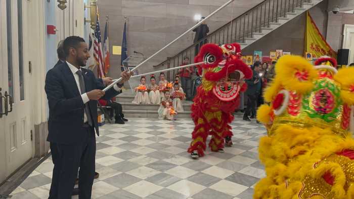 Borough President Reynoso participates in the Lion Dance.
