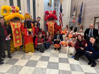Borough President Reynoso, Lion Dancers, and members of the public.