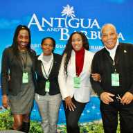 Antigua and Barbuda Tourism Authority eagerly chatted about their breathtaking island nation in the Eastern Caribbean, during the New York Travel & Adventure show, at the Jacob Javits Center in Manhattan on Jan. 24, 2026. From left are Canesha Appleton, Independent Travel Agent Kerryann Thomas, (Intele Travel) Colien Hinds, and Roderick HInds, at the Antigua and Barbuda kios against beautiful scenery of the twin-island state.