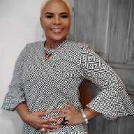 Carol A. Fraser, founder of Miracle Hands Designs, sculptor, fashion and costume designer wearing one of her creations.