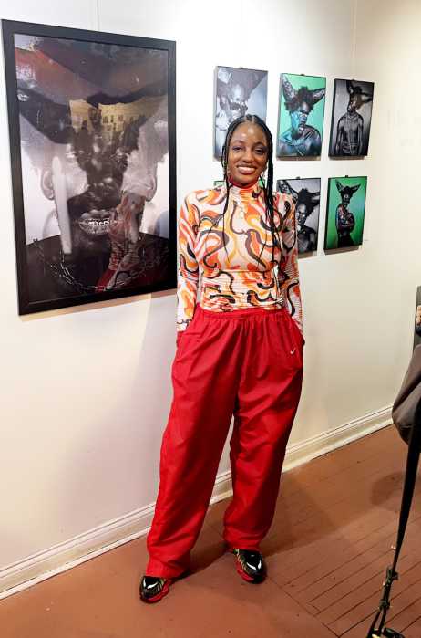 Amsterdam-based visual artist and photographer Christina Rateau stands in front of her exhibition, “Lanse Kod.” Rateau traveled from Amsterdam to Brooklyn to attend the opening of the exhibition.