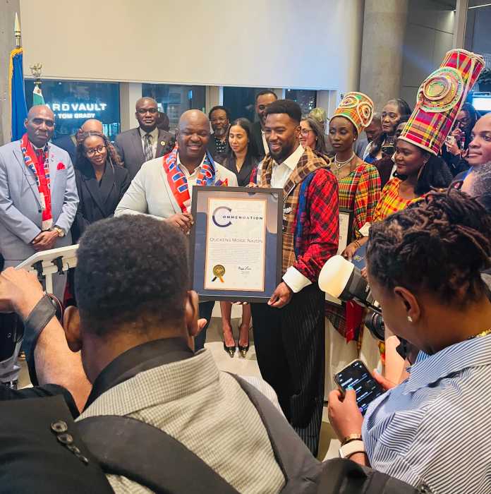 District Leader Josue Pierre poses with Duckens Nazon.