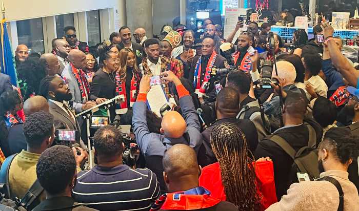 Debbie Louis and Council Member Farah Louis pose with Duckens Nazon following a citation presentation.