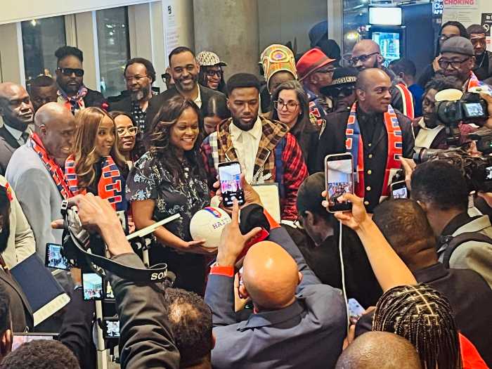 Assembly Member Rodneyse Bichotte Hermelyn poses with Haitian soccer star Duckens Nazon after presenting him with a citation.