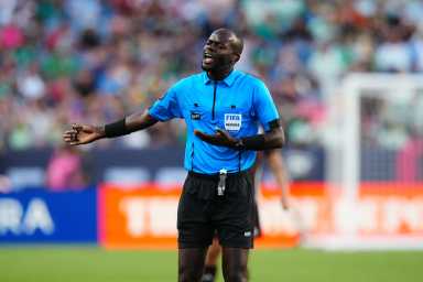 FIFA referee Oshane Nation calls out during the first half between Uruguay against Mexico at Empower Field.