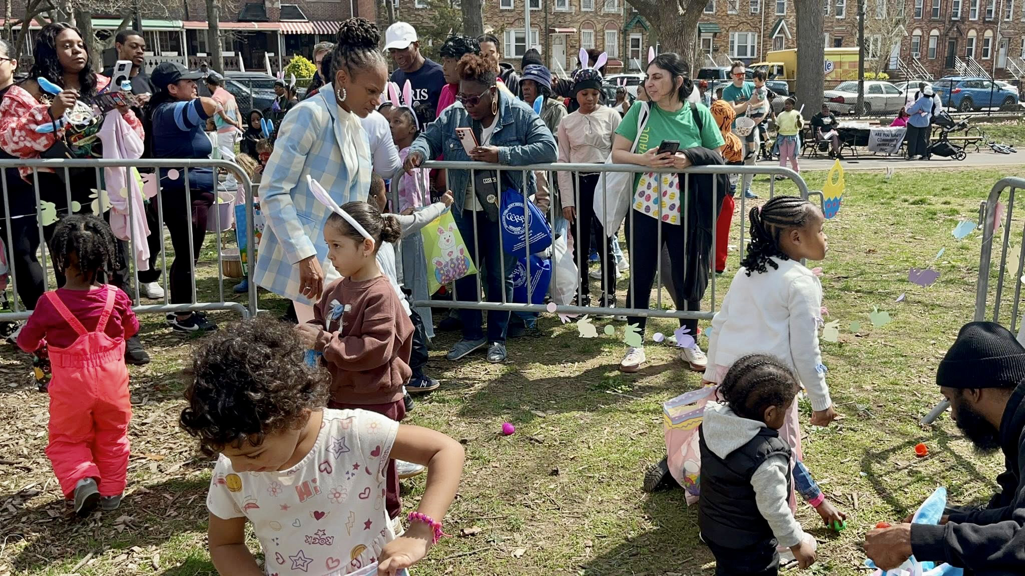 NYS Assemblywoman Monique Chandler-Waterman, looks on as a bunch of Easter Egg hunters fill their baskets with candy, at her Annual Easter hunt extravaganza, on Saturday April 4, at Paerdegat Park in Assembly District 58, Brooklyn.