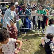 NYS Assemblywoman Monique Chandler-Waterman, looks on as a bunch of Easter Egg hunters fill their baskets with candy, at her Annual Easter hunt extravaganza, on Saturday April 4, at Paerdegat Park in Assembly District 58, Brooklyn.