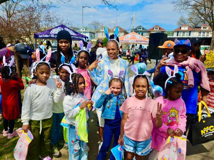 Parents and children join NYS Assemblywoman Monique, third from left (back row) at her Annual Easter Egg hunt on Saturday April 4, at Paerdegat Park in Brooklyn. The children enjoyed music, sack-racing, and face-painting.