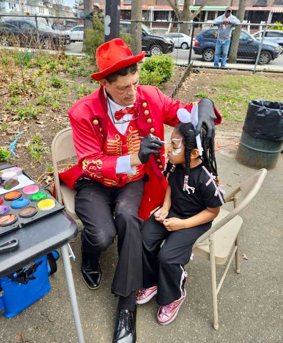 Ding-A-Ling the clown painted the faces of scores of children during the Annual Easter Egg hunt, hosted by NYS Assemblywoman Monique Chandler-Waterman. The extravaganza was held on Saturday April 4, in Paerdegat Park in Assembly District 58, Brooklyn.