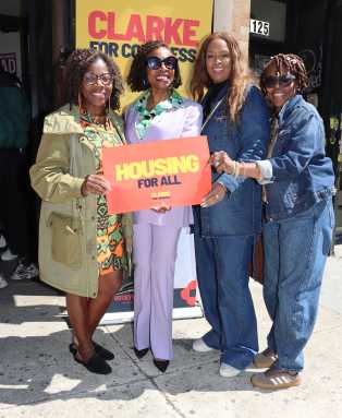 U.S. Rep. Yvette D. Clarke, second from left, with 'Housing for All' poster, flanked by her Brooklyn District Director Anita Taylor, second from right; Rose Graham, assistant principal in Brooklyn, right; and Claire Patterson-Monah, former executive director of the Brooklyn-based Guyana Cultural Association of New York, Inc., left.