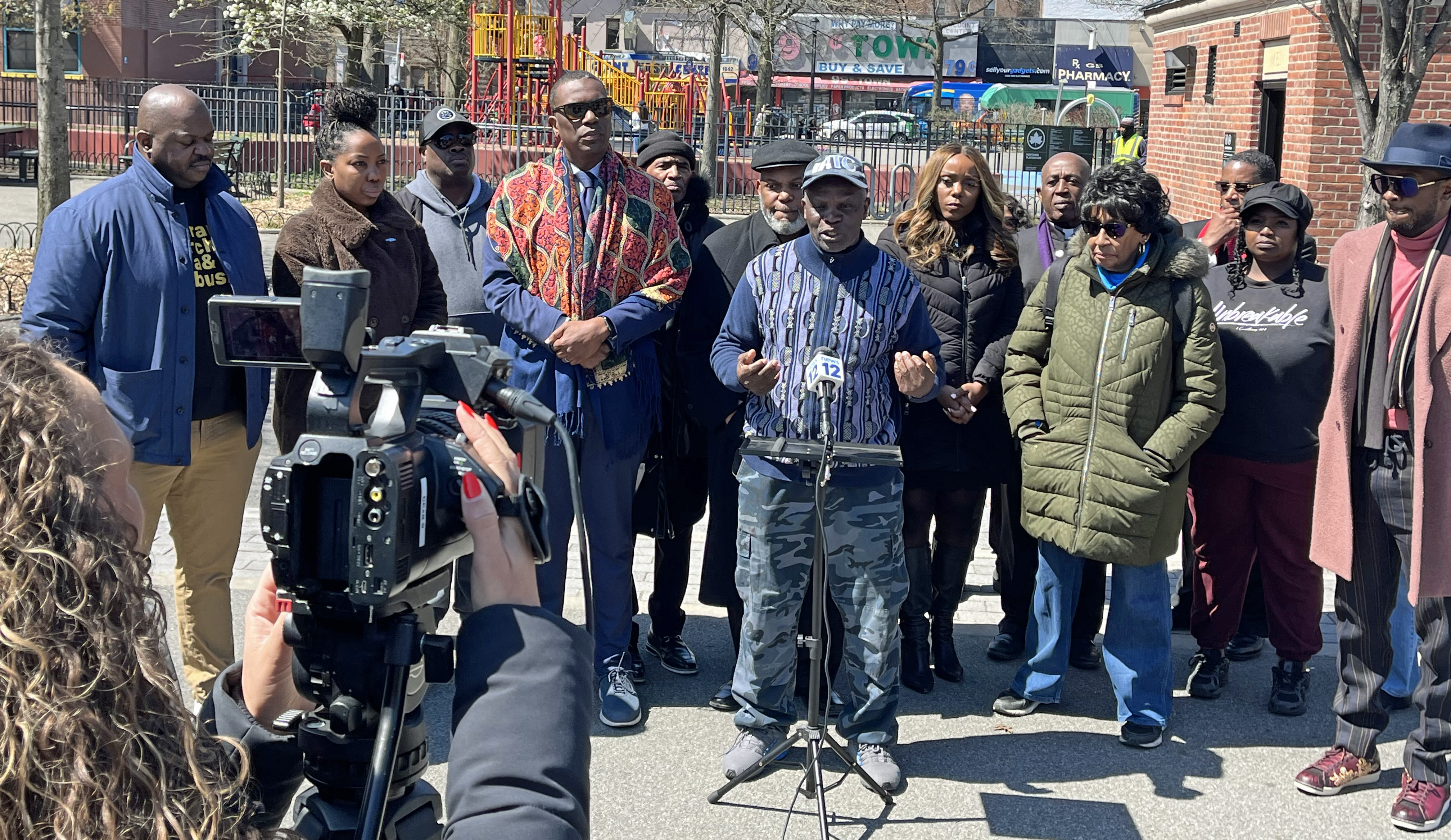Clergy members, community leaders, and residents, including Bishop Orlando Findlayter, Pastor Louis Straker, and Pastor James A. Thornton, gather in Brooklyn to support Council Member Farah Louis and her sister Debbie Louis, highlighting their integrity and service amid an ongoing federal investigation.