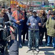 Clergy members, community leaders, and residents, including Bishop Orlando Findlayter, Pastor Louis Straker, and Pastor James A. Thornton, gather in Brooklyn to support Council Member Farah Louis and her sister Debbie Louis, highlighting their integrity and service amid an ongoing federal investigation.