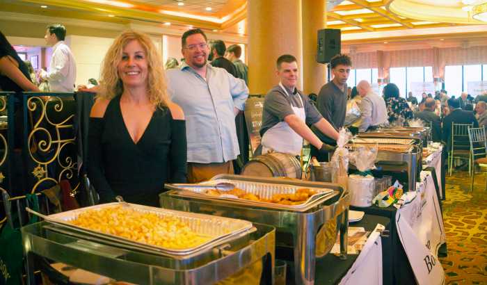 Guests sample a variety of dishes from local restaurants during Queens Centers for Progress’ “Evening of Fine Food” in Queens.