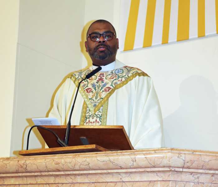 Fr. Alonzo Cox delivers the homily during the funeral of Dr. Roland Purcell.