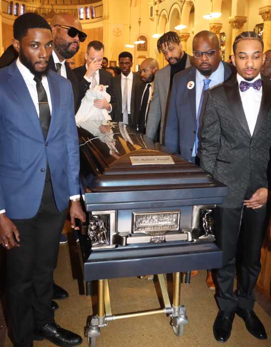 Pall bearers with Dr. Roland Purcell’s casket as they depart the Holy Family Roman Catholic Church on Flatlands Avenue in Canarsie, Brooklyn.