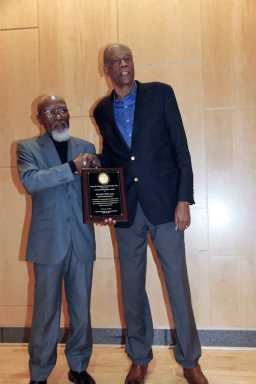 Moderator Jose Richards (left) presents plaque to Bob Law.