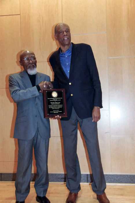 Moderator Jose Richards (left) presents plaque to Bob Law.