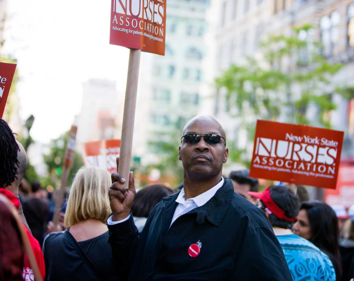 New York, USA - May 1, 2012: Man holding NY Nurses Association banner on Union Square during 1st May demonstration.