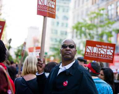 New York, USA - May 1, 2012: Man holding NY Nurses Association banner on Union Square during 1st May demonstration.