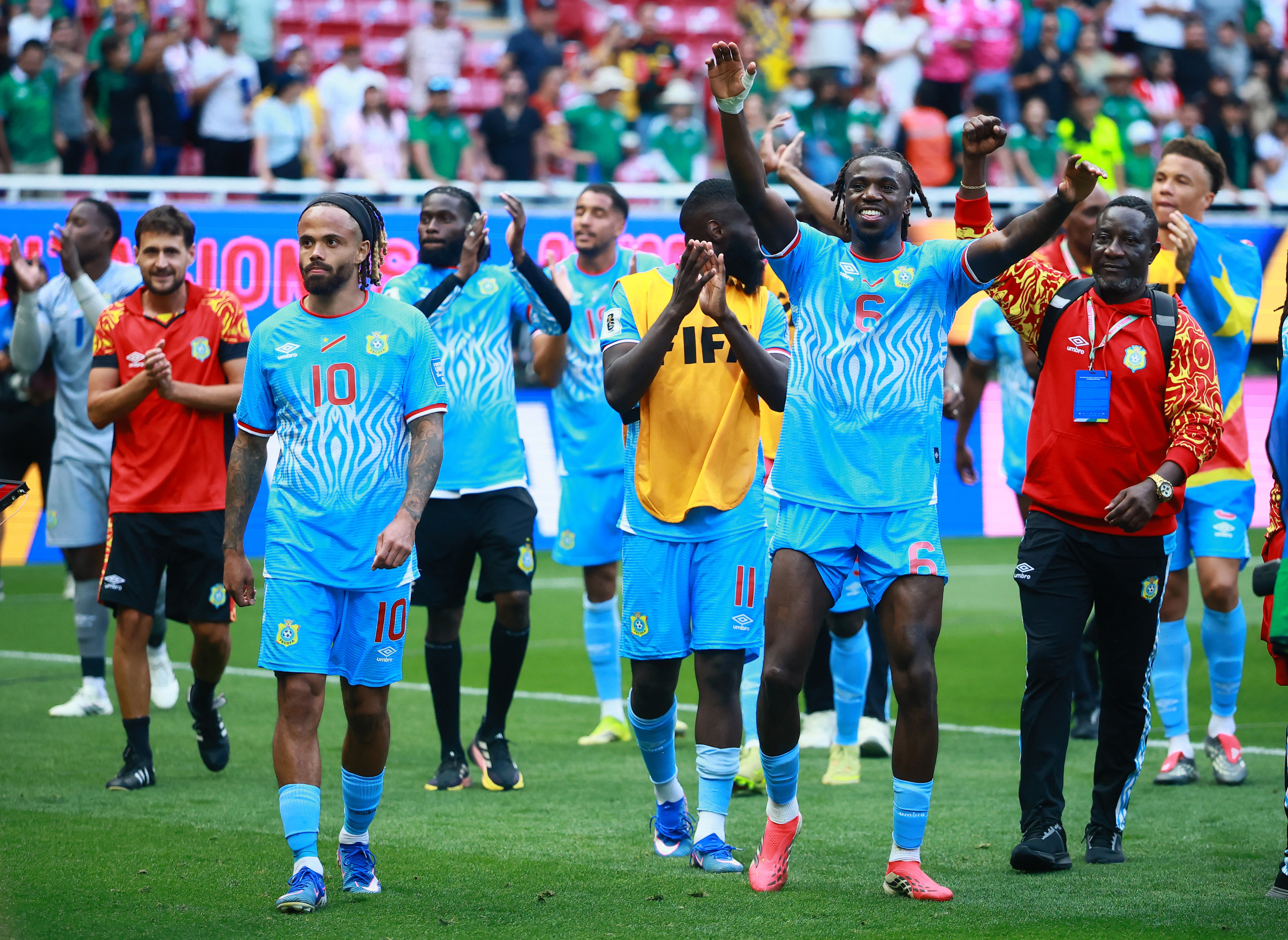 DR Congo's Ngal'ayel Mukau and Theo Bongonda celebrate qualifying for the FIFA World Cup.