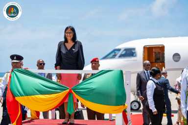 Acting Venezuelan President Delcy Rodriguez takes the salute by the Honor Guard following her arrival at the Maurice Bishop International Airport in Grenada.