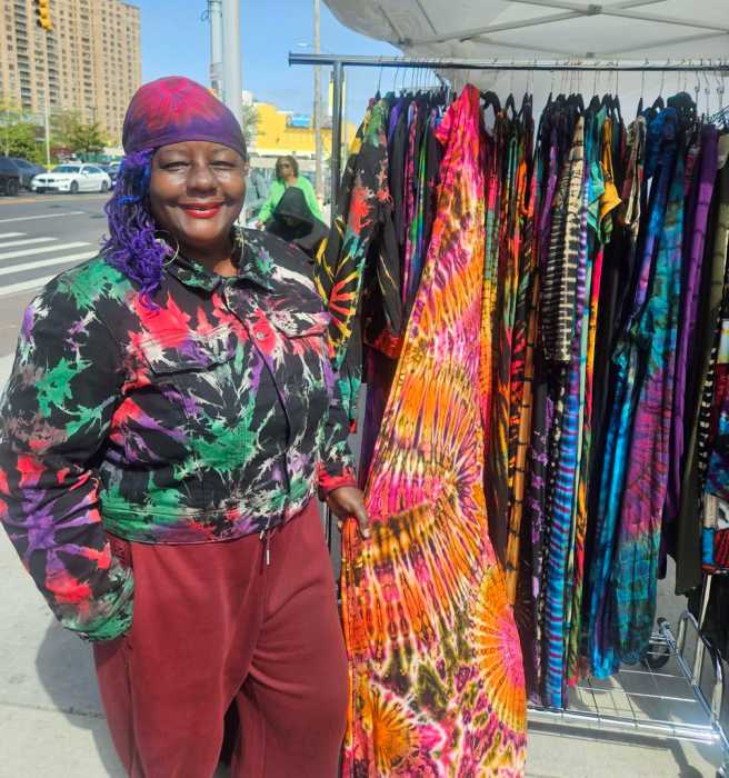 Sandra, creative owner of the San Jules Tie Dye brand shows off her collection of clothing, handbags, Tees, and Jewelry during Saturday, April 18, Little Caribbean and I Am CaribBeing marketplace at the intersection of Washington Avenue and Empire Boulevard in Brooklyn.