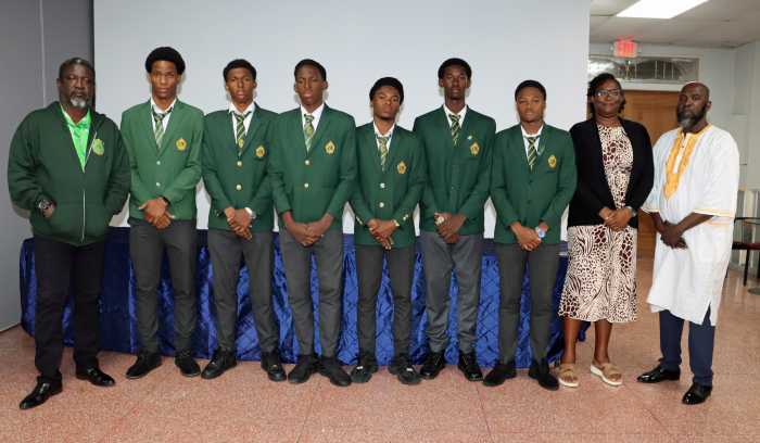 James Cordice, coordinator of the SVG Penn Relays initiative, far right, with Grammar School athletes, Team Manager Justine Douglas, second from right, and Rawlson Morgan, left.