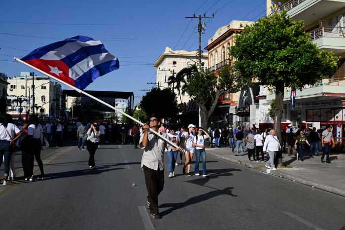 A man waves a Cuban flag after a ceremony marking the 65th anniversary of Fidel Castro's declaration of the socialist character of the Cuban Revolution, made on the eve of the Bay of Pigs invasion in 1961, in Havana, Cuba April 16, 2026.