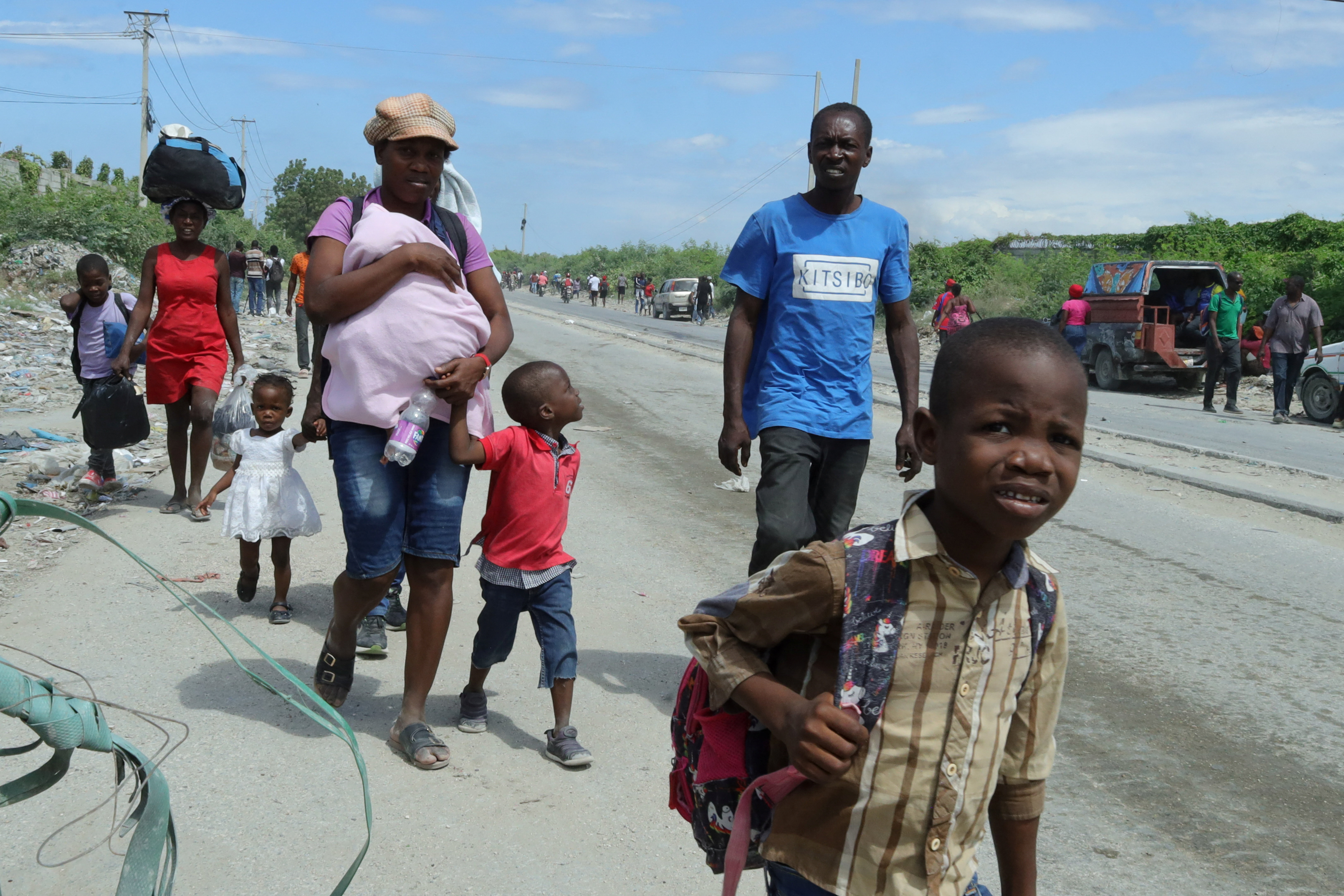 Residents walk along a street while fleeing their homes in Cite Soleil after rival gang clashes in Haiti's capital worsened over the weekend, in Port-au-Prince, Haiti, May 11, 2026.