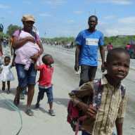 Residents walk along a street while fleeing their homes in Cite Soleil after rival gang clashes in Haiti's capital worsened over the weekend, in Port-au-Prince, Haiti, May 11, 2026.