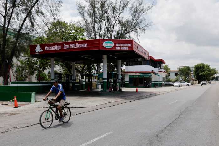 A man pedals a bicycle past an empty gas station as the country plans to implement variable fuel prices to reflect the actual costs of importing gasoline and diesel amid a U.S. blockade that has strangled the island of fuel, in Havana, Cuba, May 15, 2026.