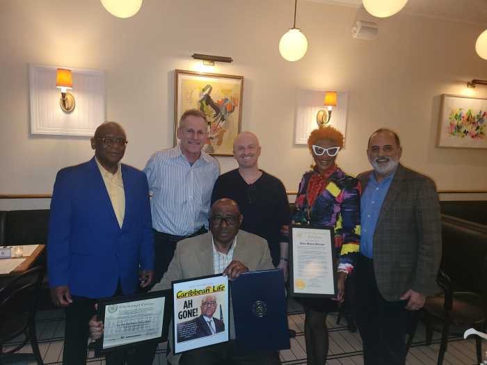 Kevin Williams, seated, with proclamations and citations, flanked by, L-R: Dr. Nelson A. King, Clifford Luster, Joshua Schneps, Tangerine Clarke and Ralph D'Onofrio.