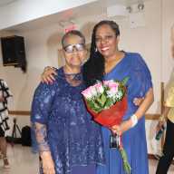 Judge Sheridan Jack-Browne, right, receives bouquet of flowers from her "oldest friend" Doris McIntosh.