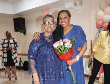 Judge Sheridan Jack-Browne, right, receives bouquet of flowers from her "oldest friend" Doris McIntosh.
