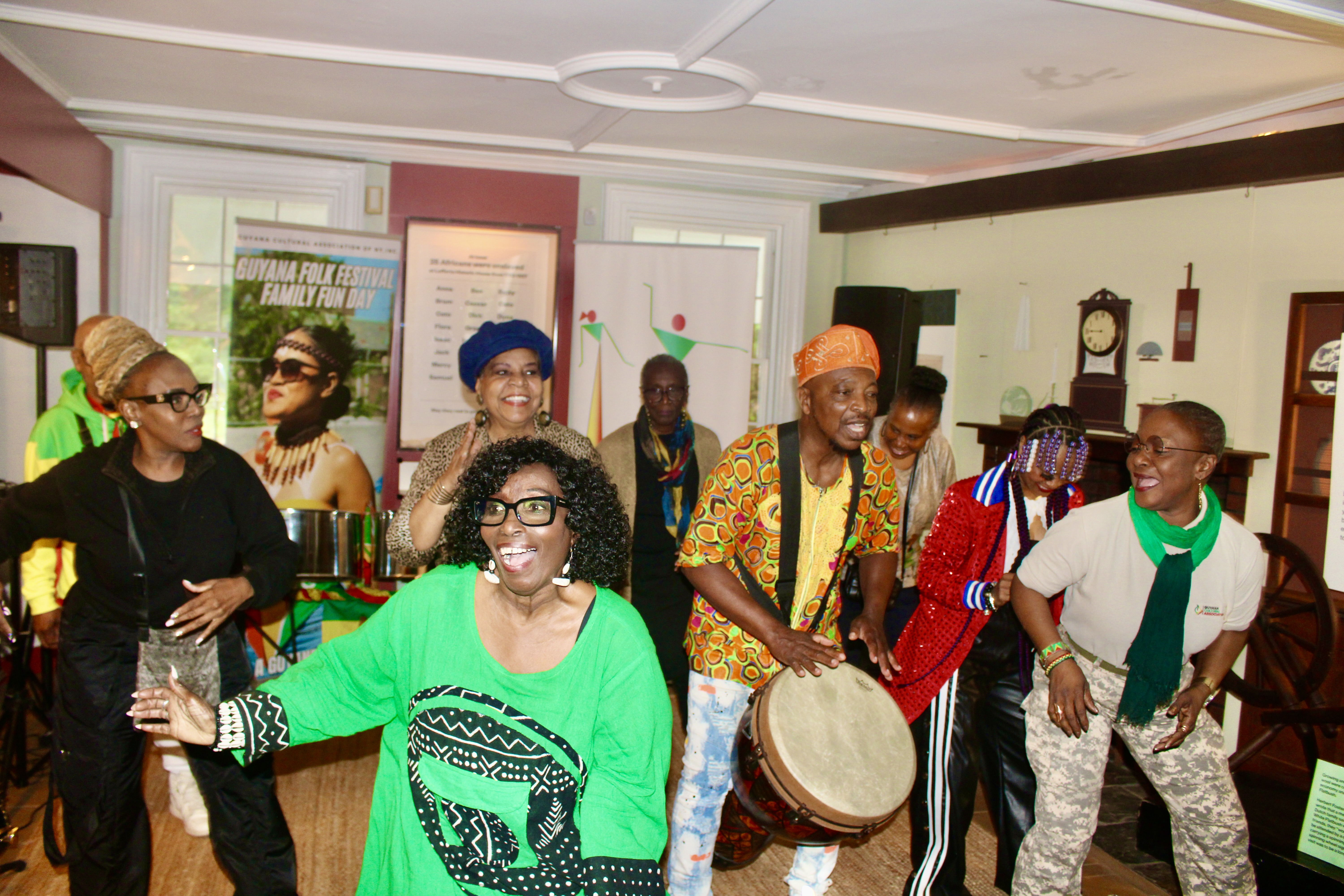 Members of the Guyana Cultural Association NY Inc. from left (front-row) Verna Walcott-White, Akoyaw Rudder, and Rose October join musicians and audience members during a finale performance in the Prospect Park Lefferts Historic House Museum on May 24 at a pop-up concert to celebrate Guyana's 60th (Diamond Jubilee) Independence Anniversary Day on May 26, 2026.