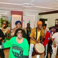 Members of the Guyana Cultural Association NY Inc. from left (front-row) Verna Walcott-White, Akoyaw Rudder, and Rose October join musicians and audience members during a finale performance in the Prospect Park Lefferts Historic House Museum on May 24 at a pop-up concert to celebrate Guyana's 60th (Diamond Jubilee) Independence Anniversary Day on May 26, 2026.