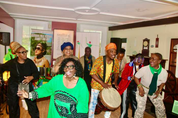 Members of the Guyana Cultural Association NY Inc. from left (front-row) Verna Walcott-White, Akoyaw Rudder, and Rose October join musicians and audience members during a finale performance in the Prospect Park Lefferts Historic House Museum on May 24 at a pop-up concert to celebrate Guyana's 60th (Diamond Jubilee) Independence Anniversary Day on May 26, 2026.